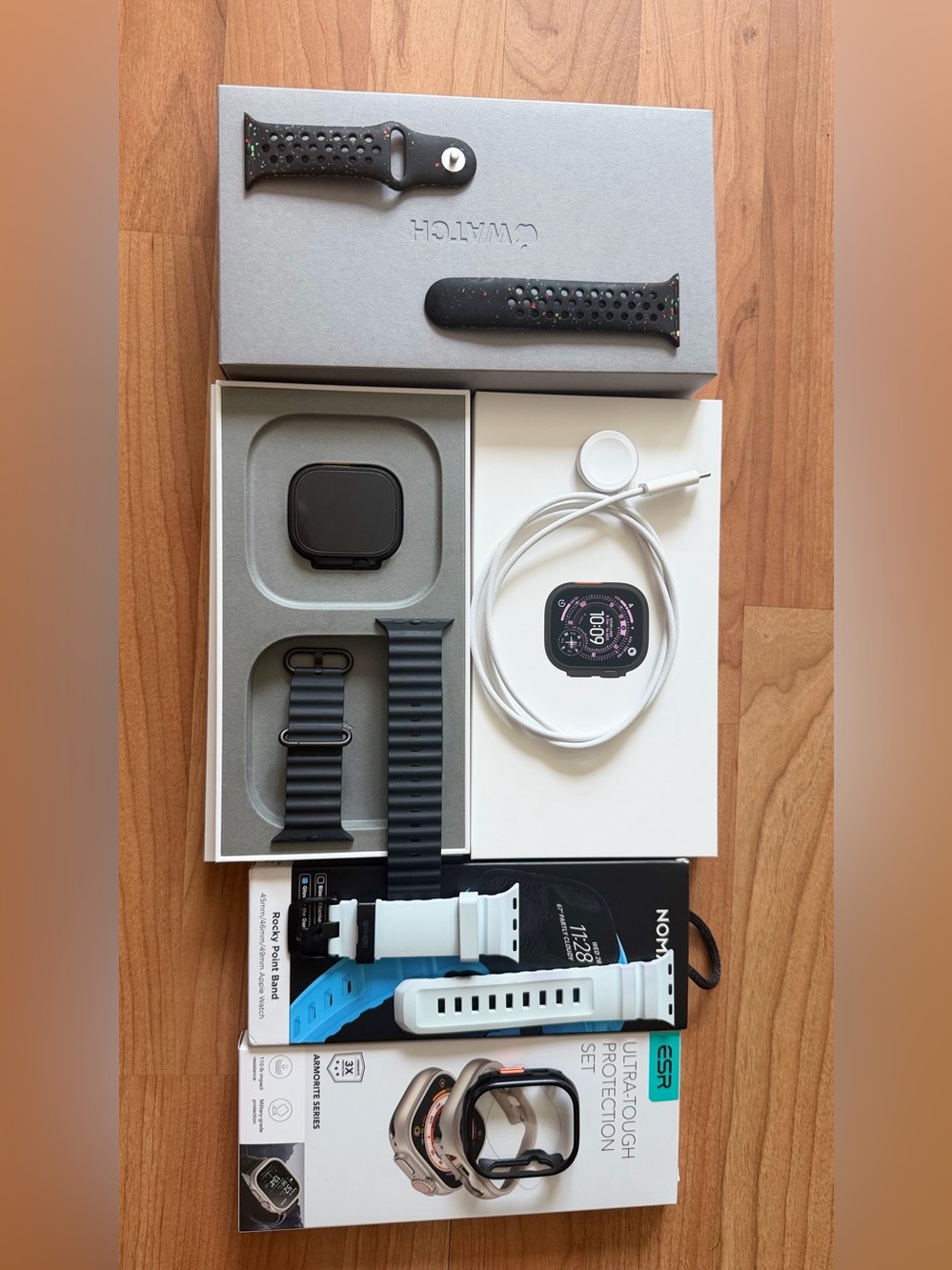 Apple Watch with Black Case and White & Blue Replacement Bands